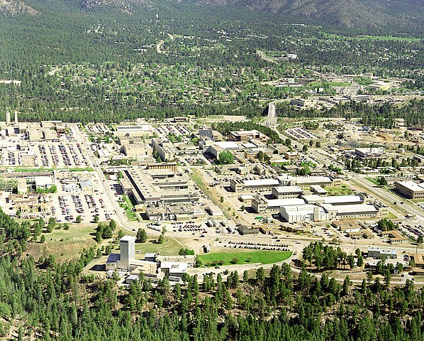 Aerial view of the Los Alamos campus among forested hills